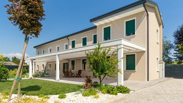 Pergola addossata bianca su facciata con copertura in policarbonato – PC2604